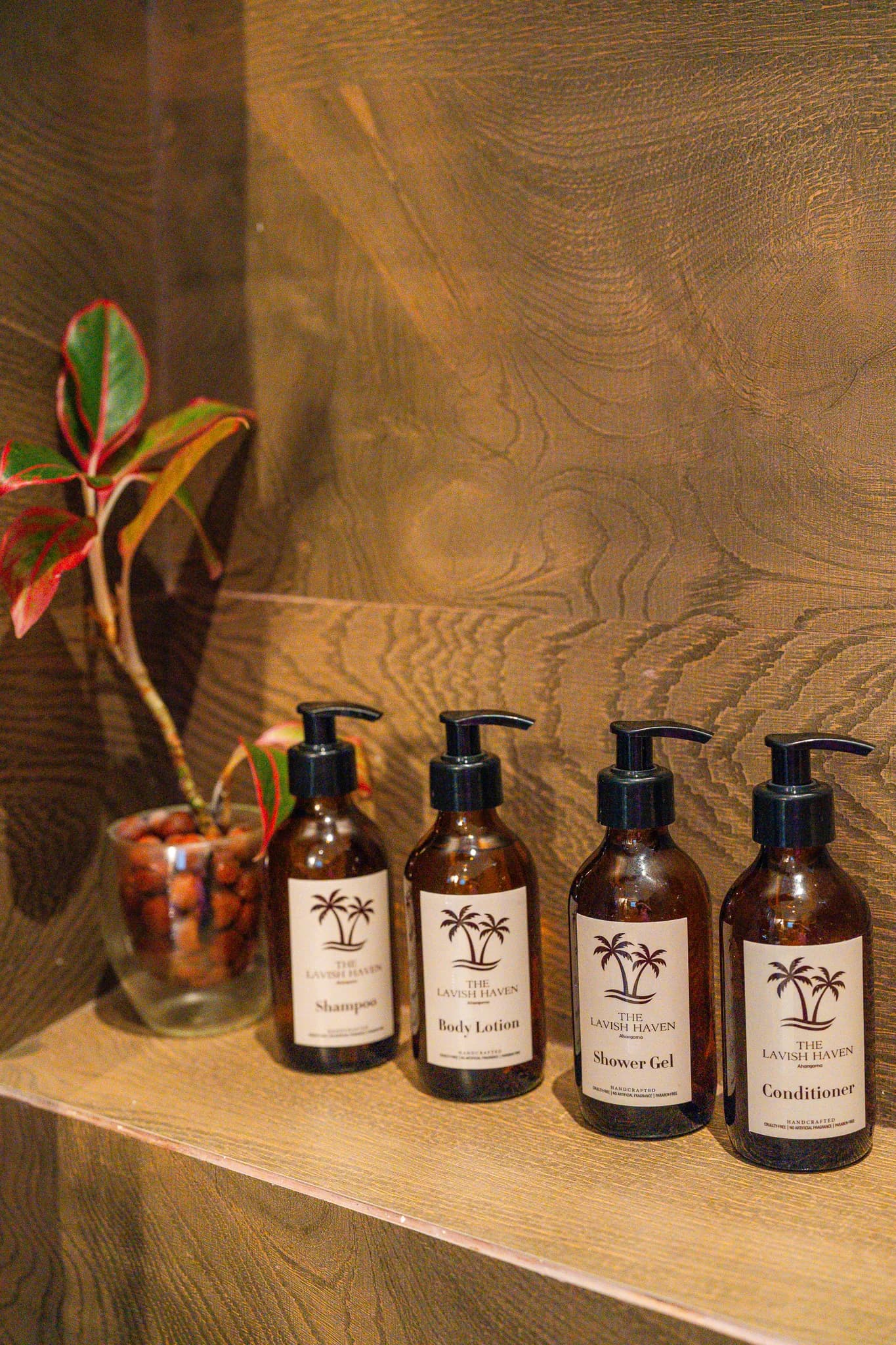 Bathroom amenity bottles with the Haven's palm motif
