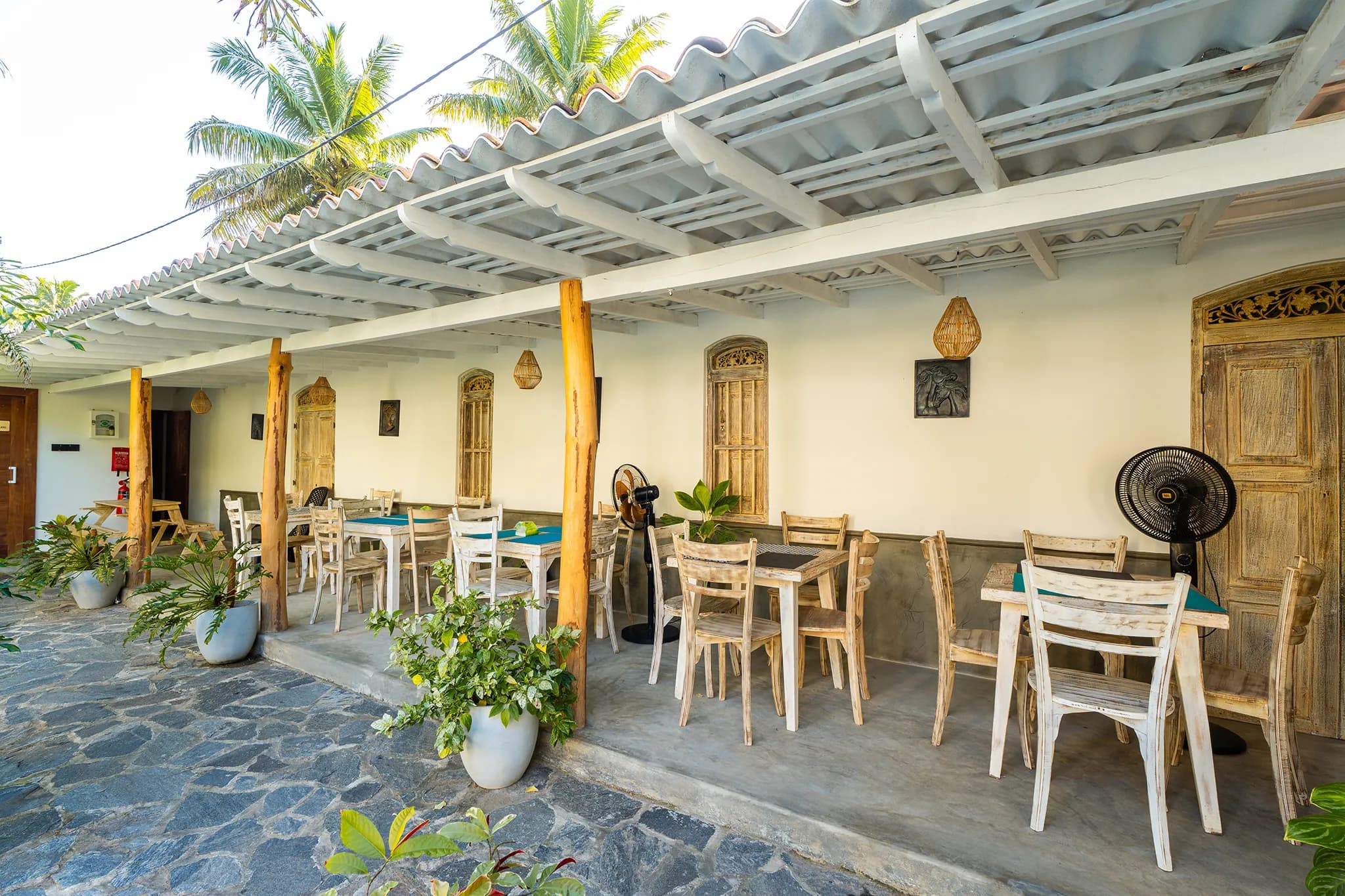 Restaurant tables beneath the white timber ceiling