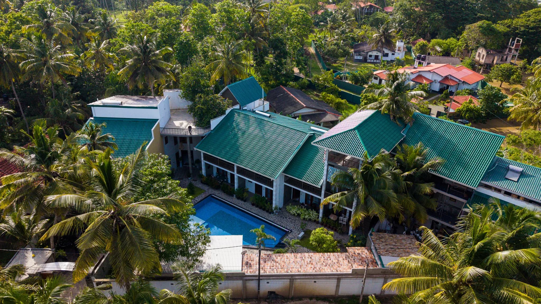 The hotel among coconut palms from above