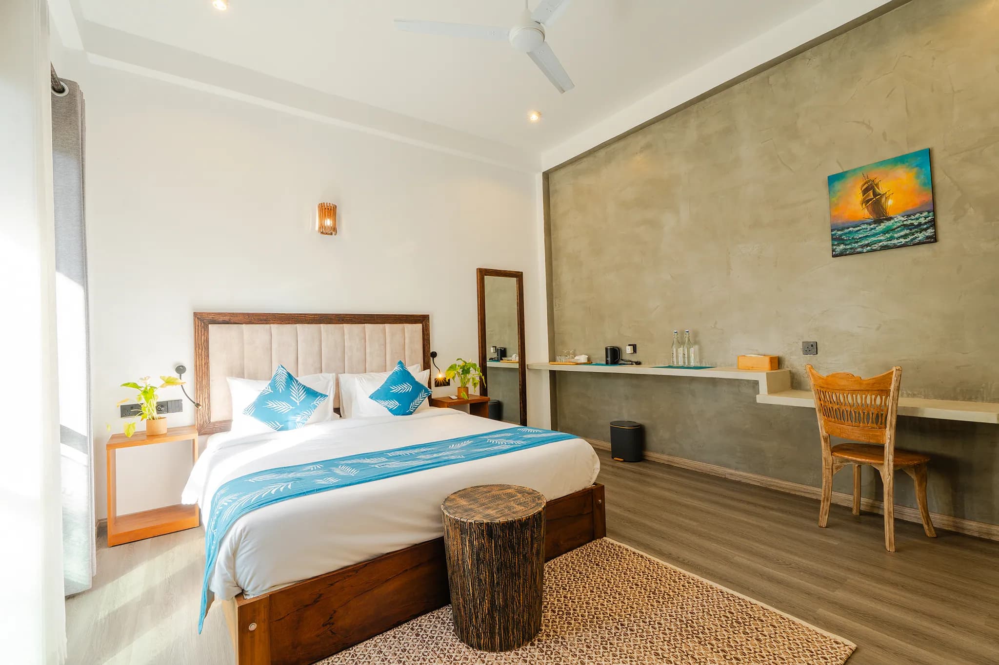 Bed, desk and chair beneath a vaulted ceiling
