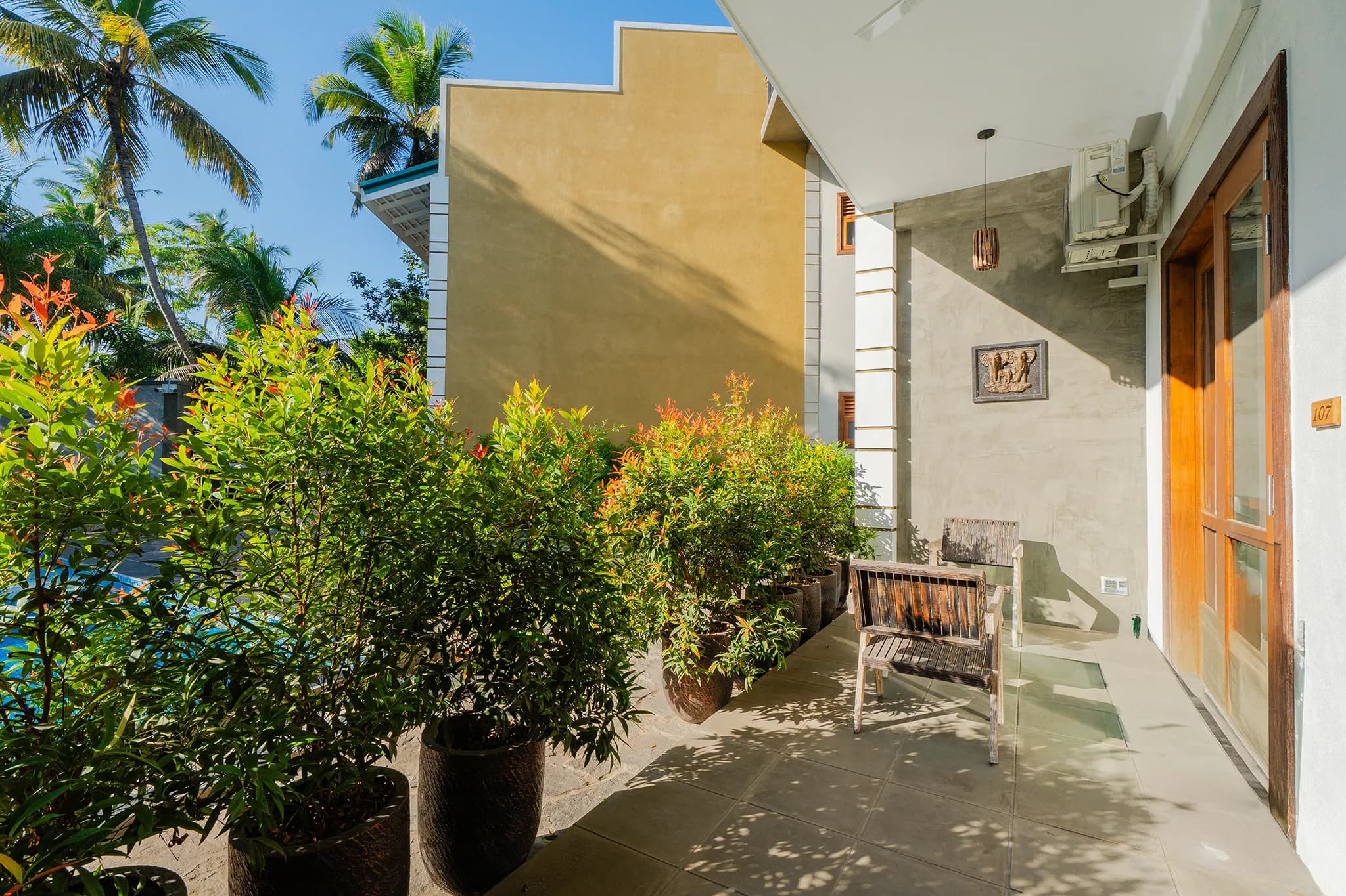 Ground-floor patio with potted plants and seating