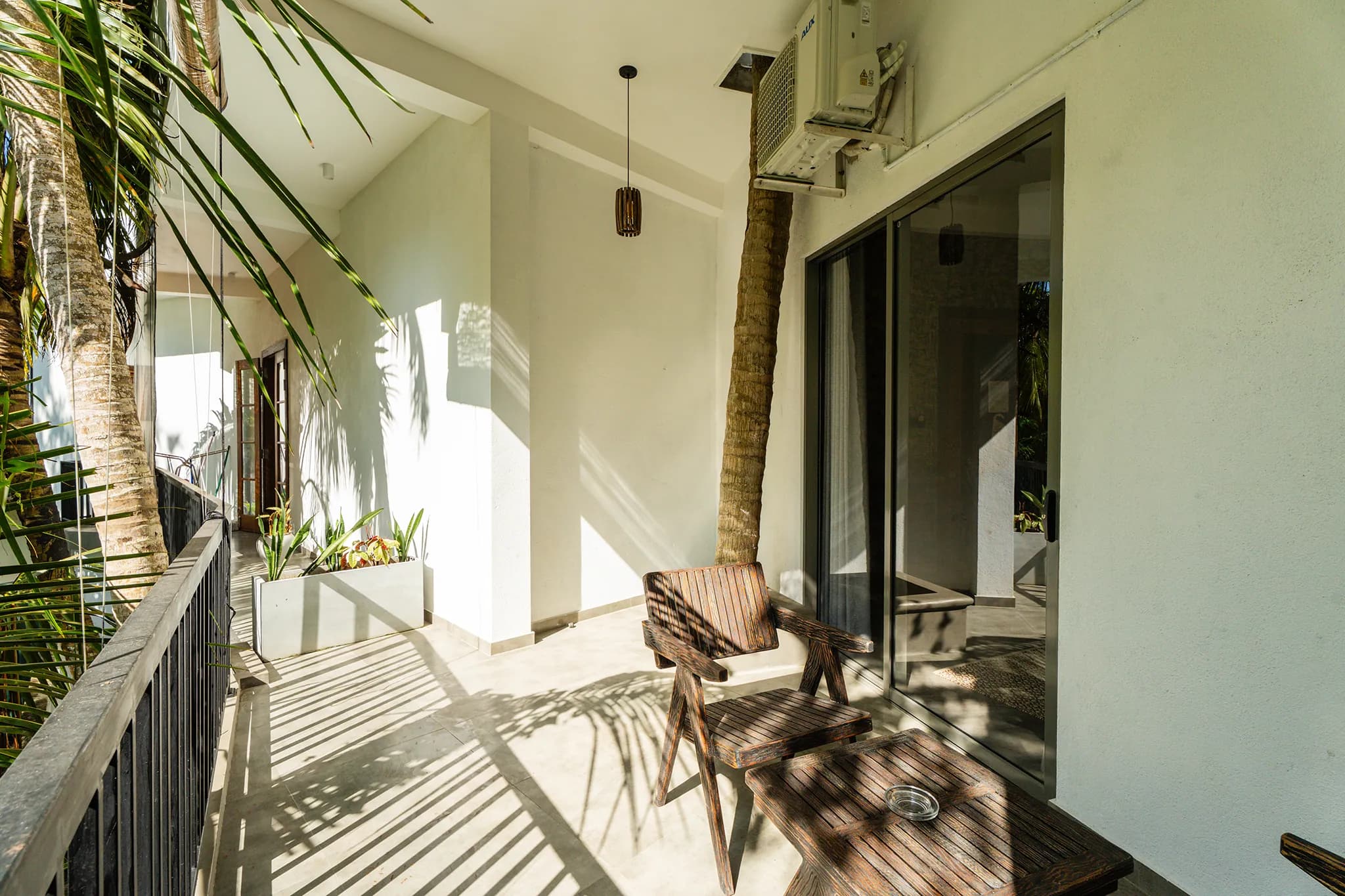 First-floor balcony with timber bench overlooking the garden