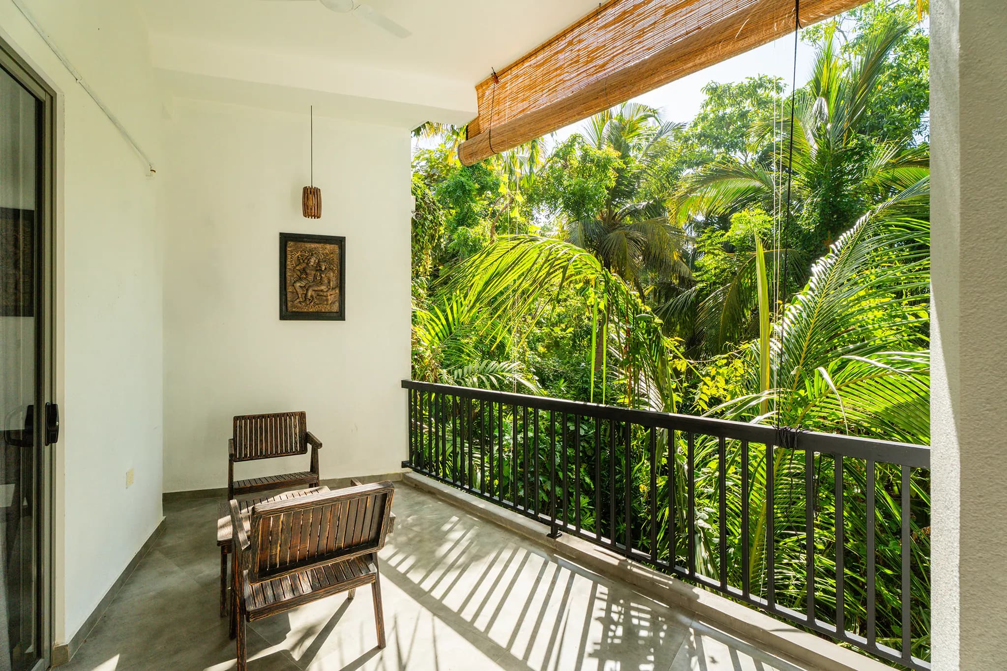 Second balcony looking over the pool and palms