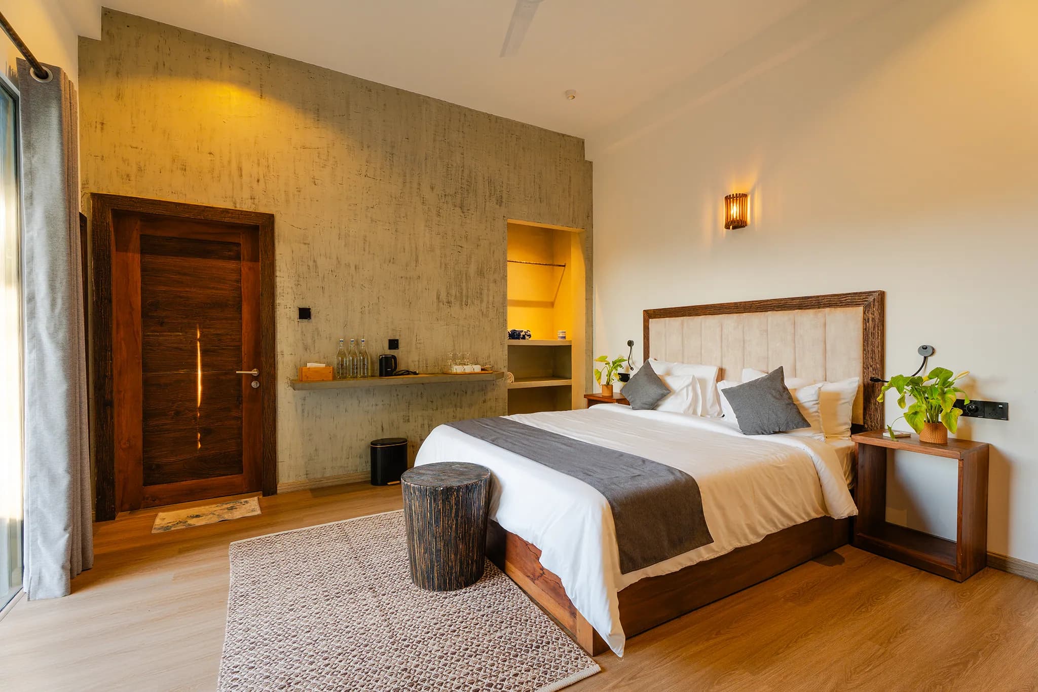 King bed with grey throw and timber headboard