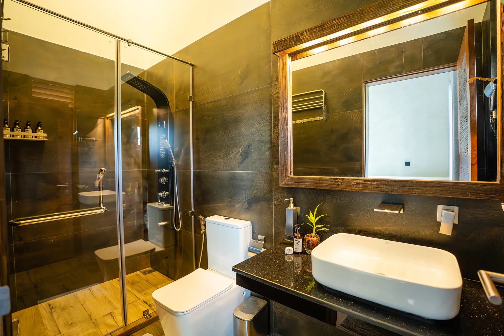 Dark-stone bathroom with shower column