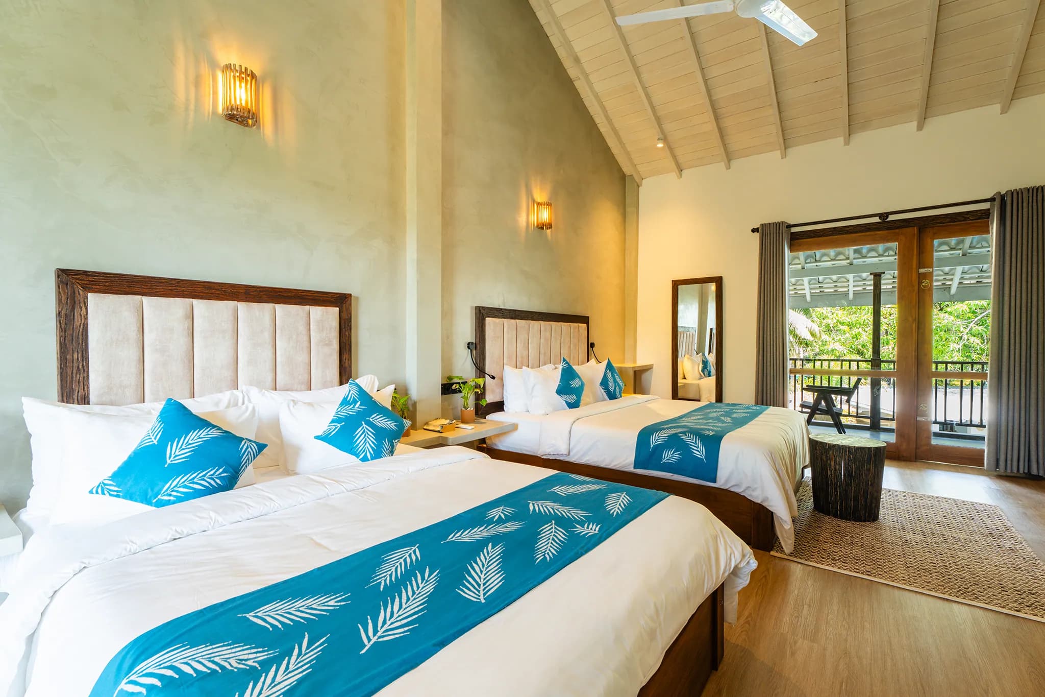 Two beds with blue palm-print runners