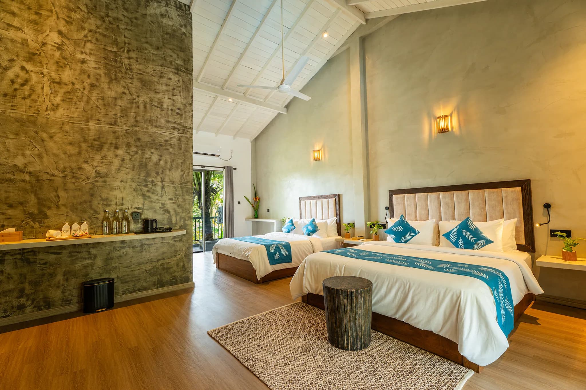 Two beds beside a stone feature wall