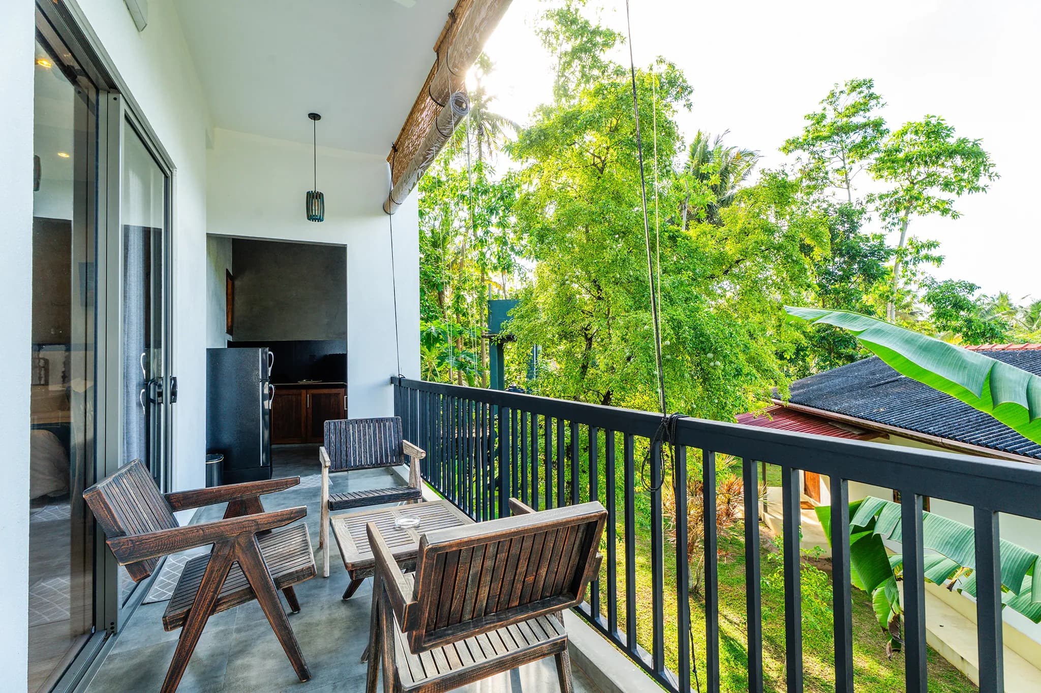Balcony with seating and a kitchenette with fridge