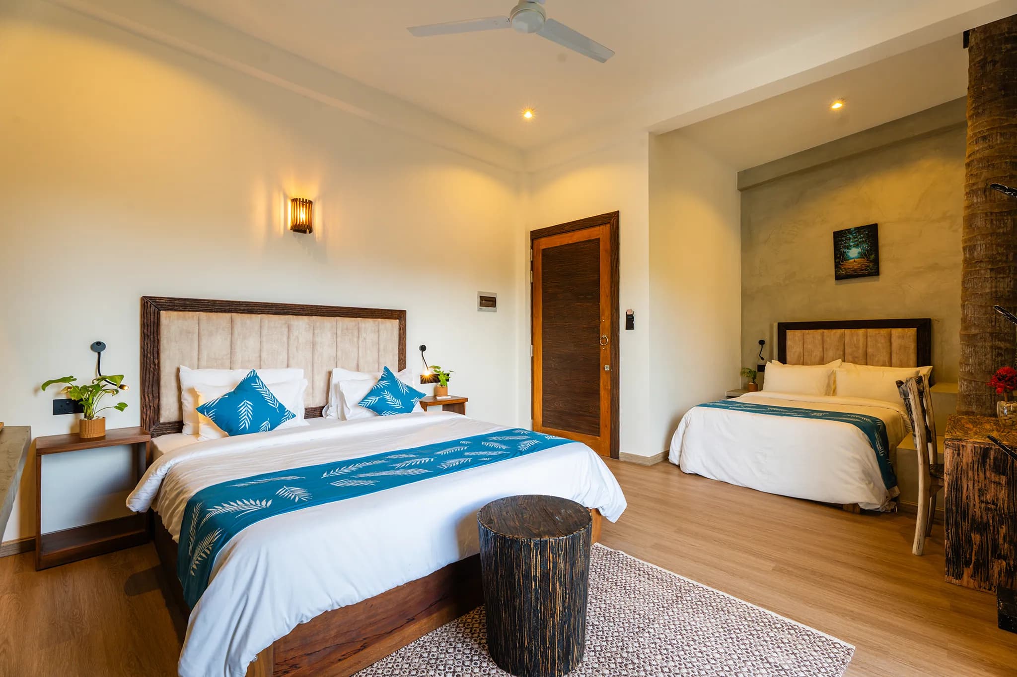 King bed with palm-print runner and cushions