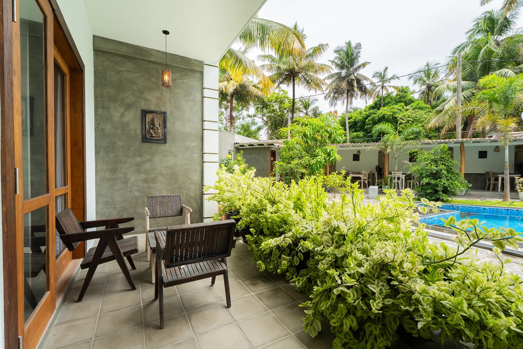 Private patio with chairs looking onto the pool