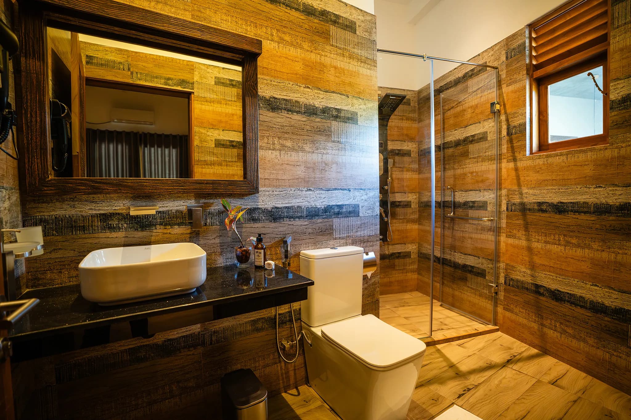 Wood-clad bathroom with glass shower