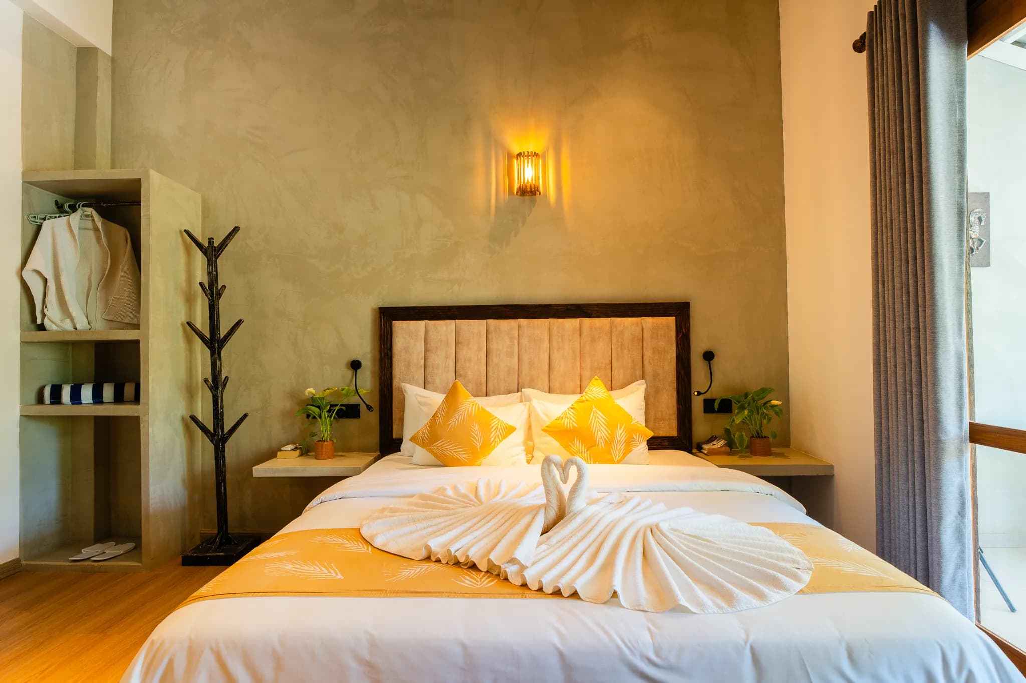 Open wardrobe and coat stand beside the bed