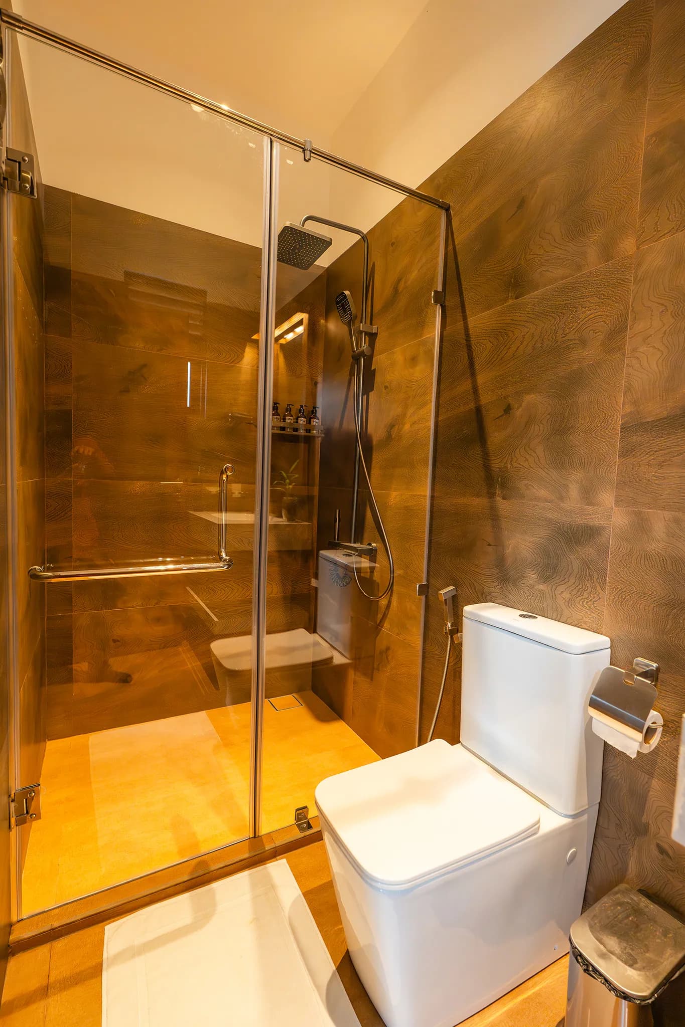Wood-panelled bathroom with walk-in shower