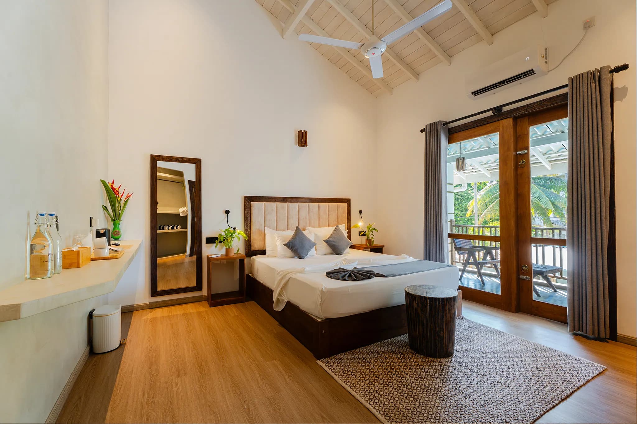 King bed with timber doors opening to a balcony