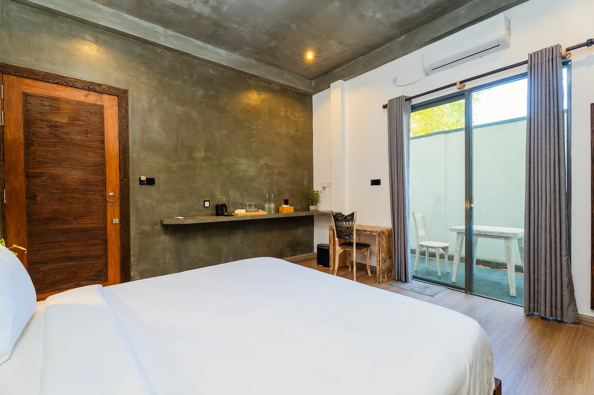 King bed with doors to a private terrace
