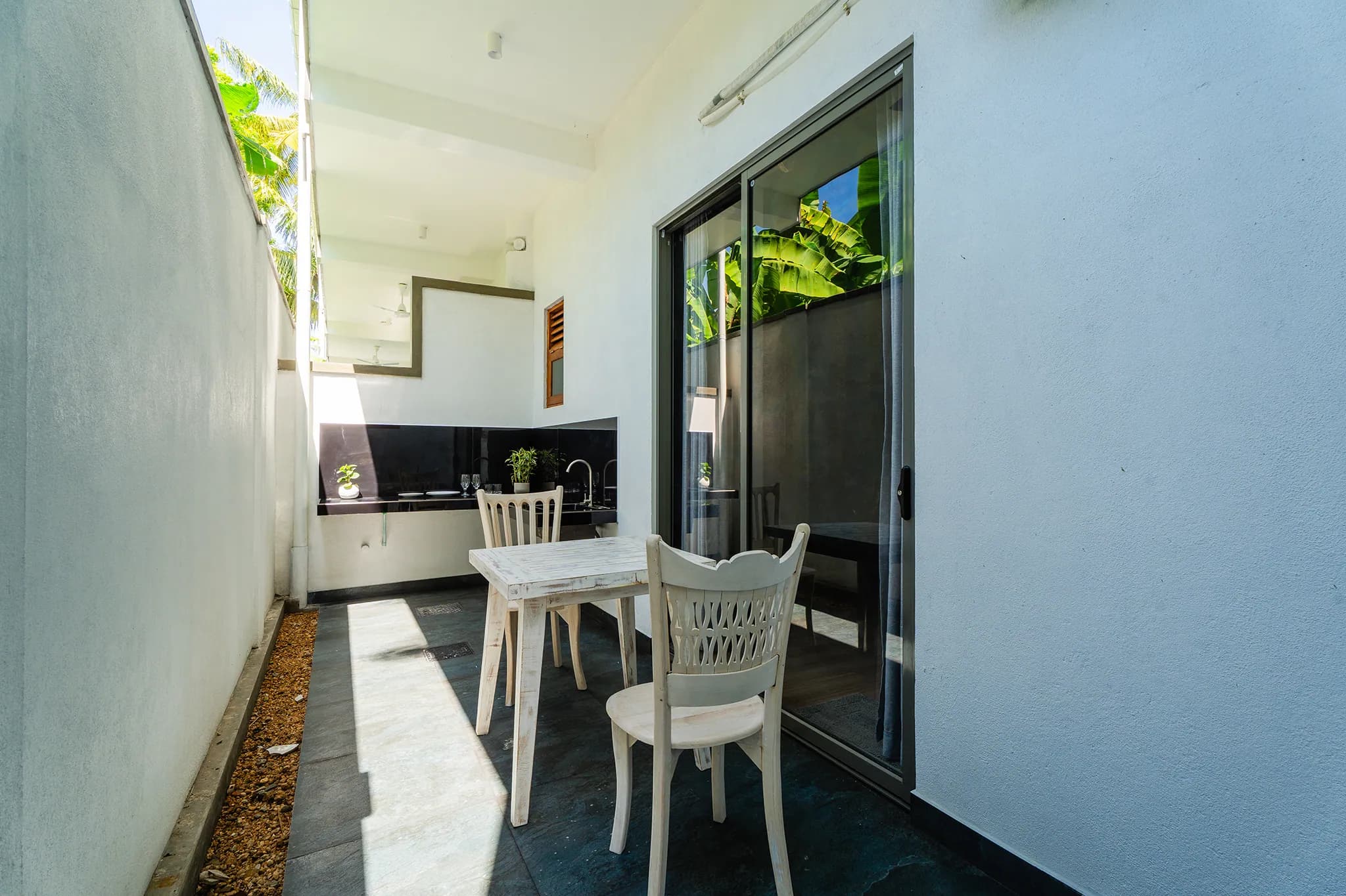 Private kitchenette with a white dining table and chairs