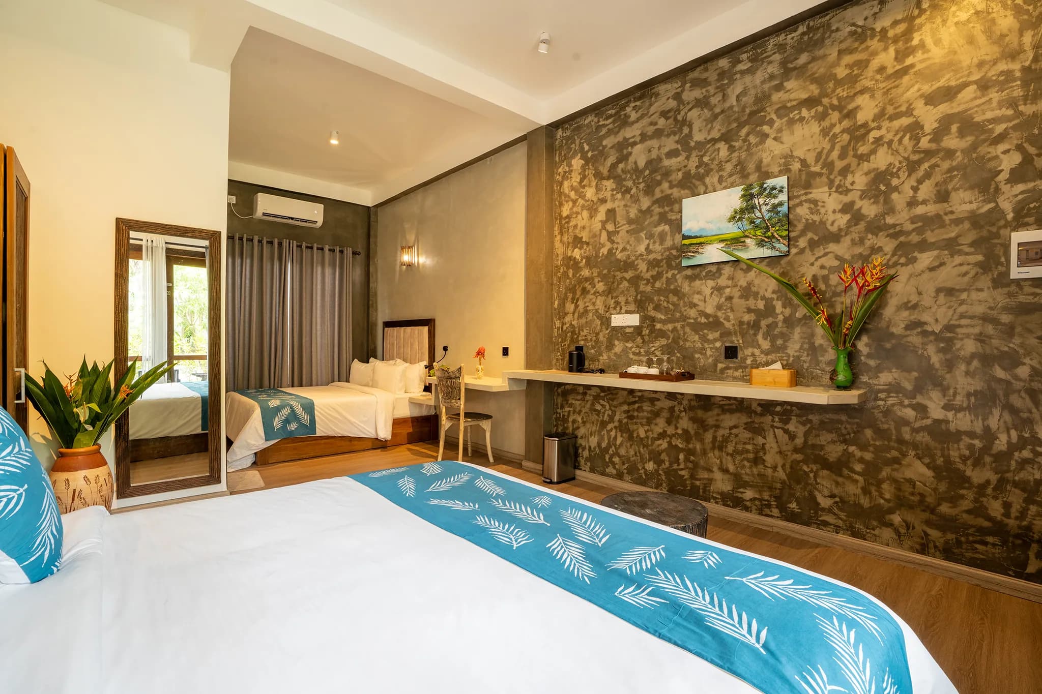 King bed against a textured concrete feature wall