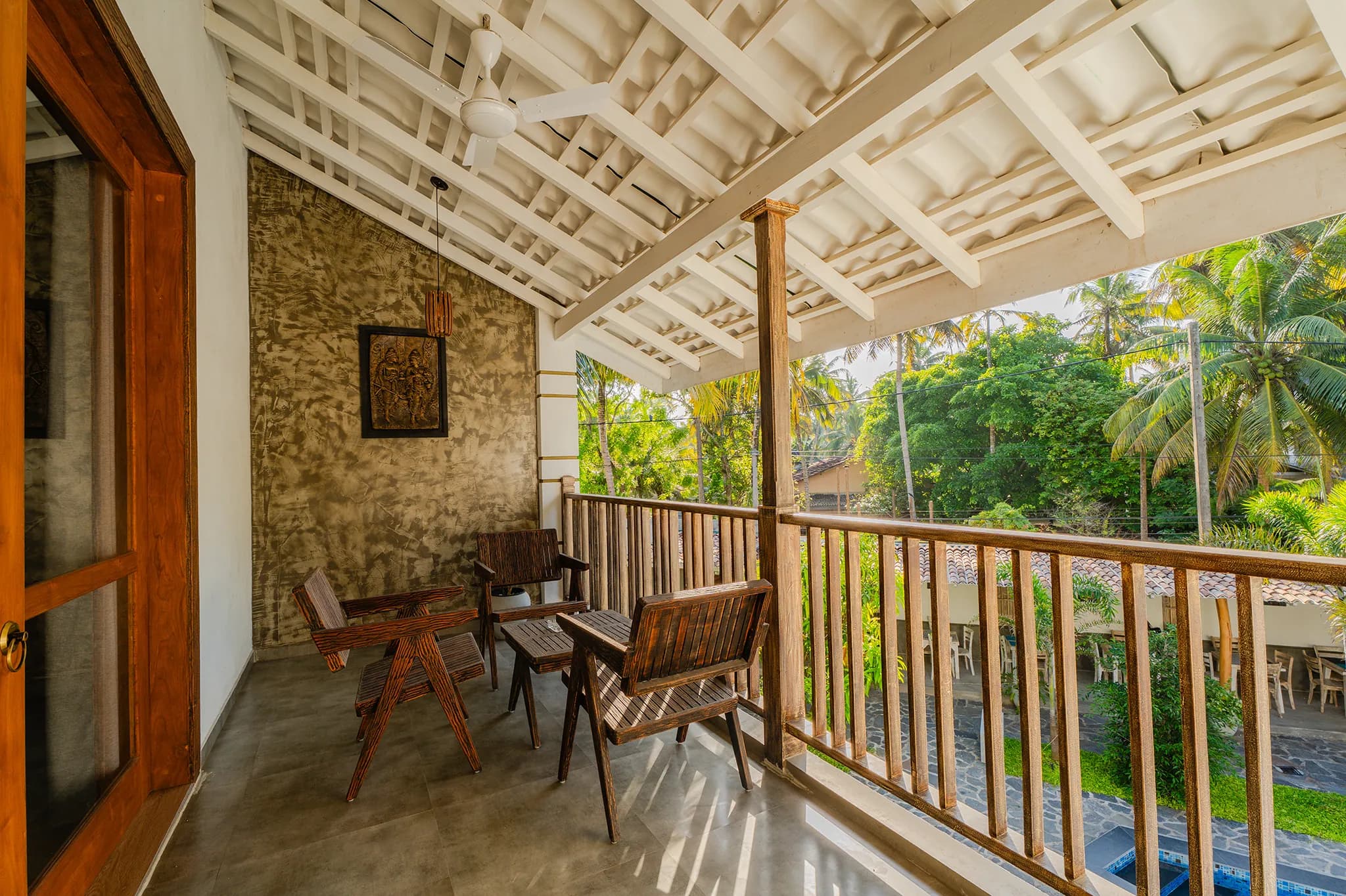 A balcony beneath the white gabled roof