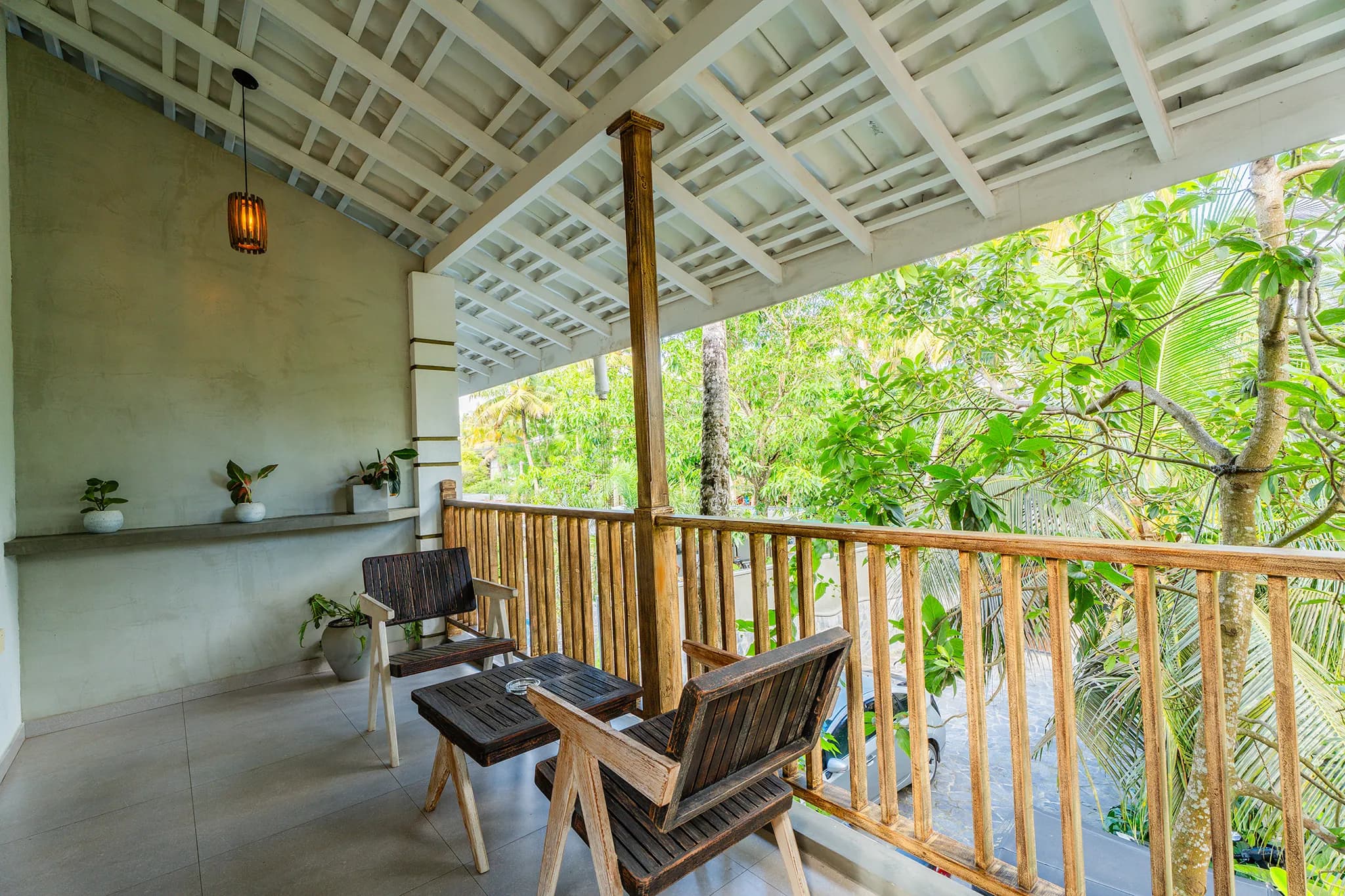 Balcony chairs framed by palms