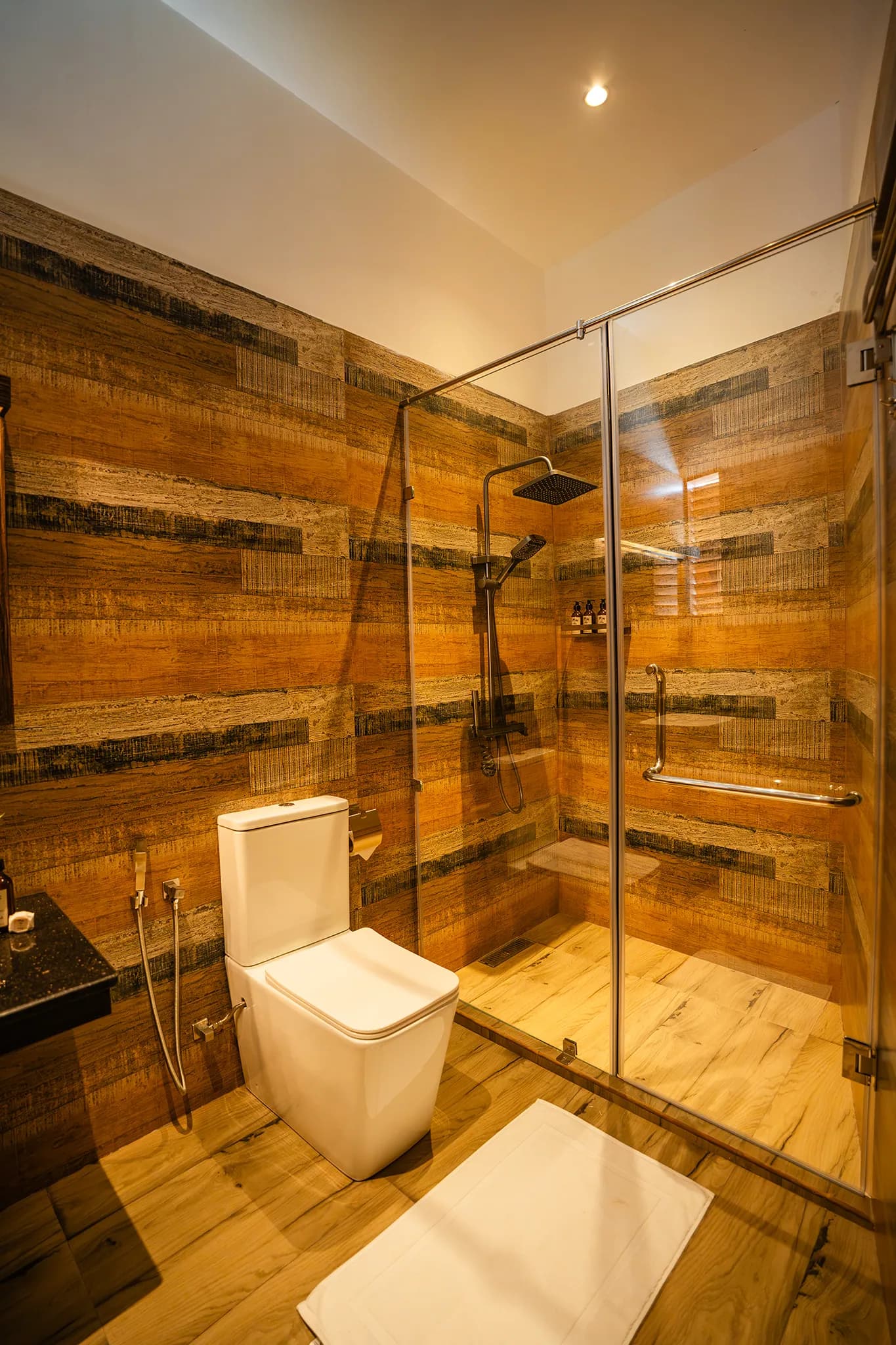 Wood-panelled bathroom with walk-in rain shower