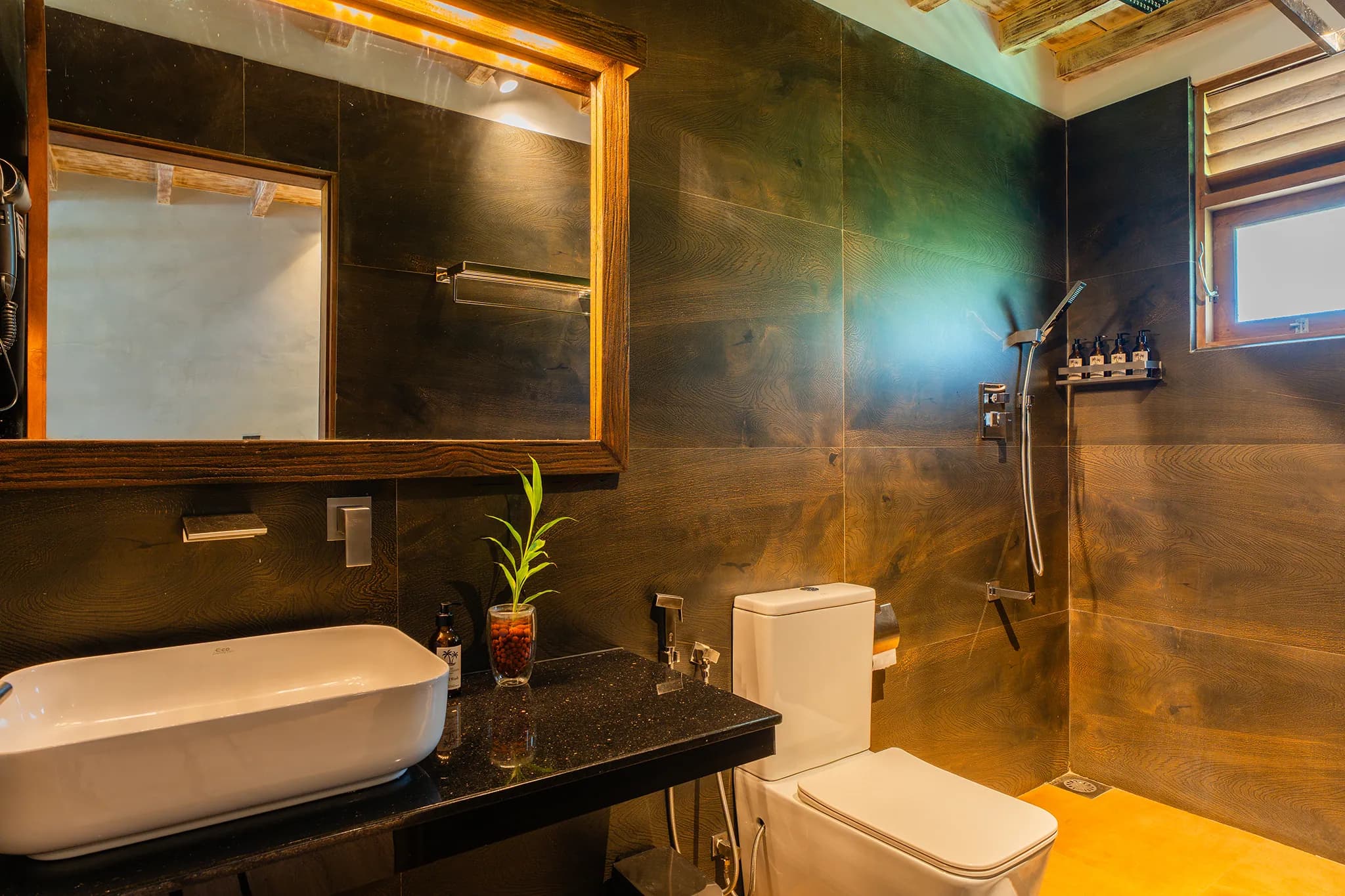Dark-tiled bathroom with walk-in shower