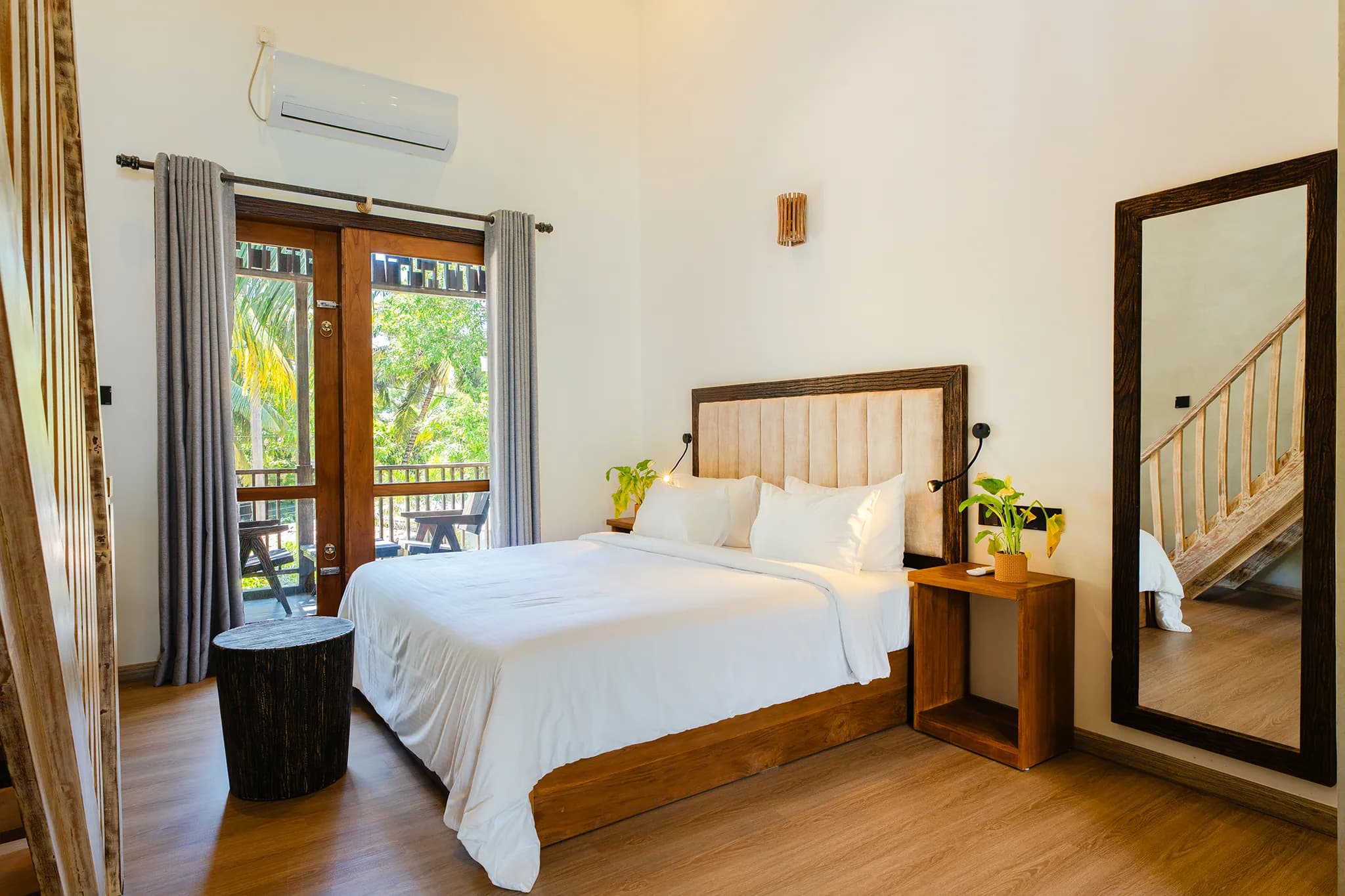 King bed with doors to a balcony in the two-bedroom suite