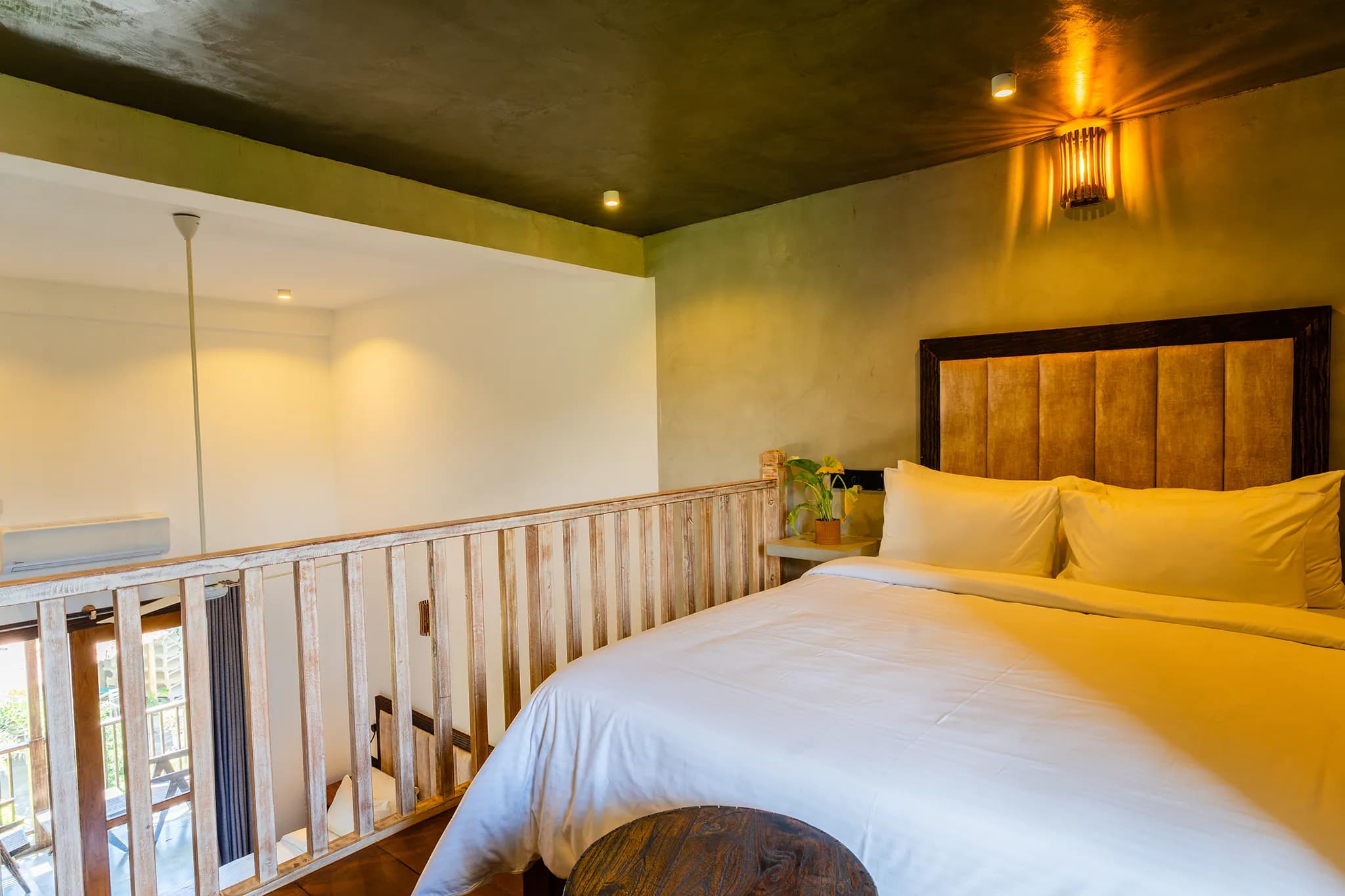 Mezzanine bedroom with king bed and dark-green walls