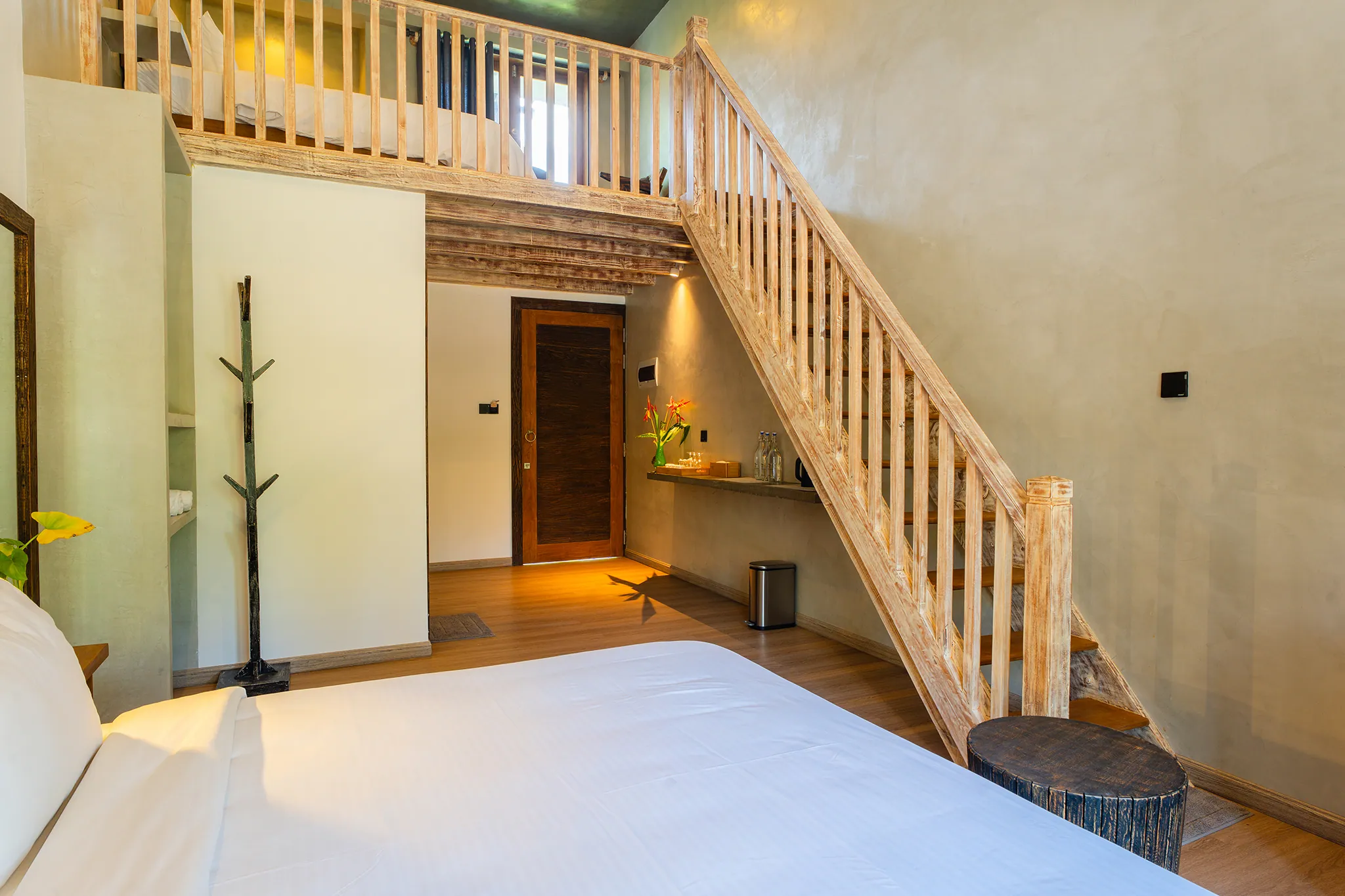 Lower bedroom with staircase and coat stand