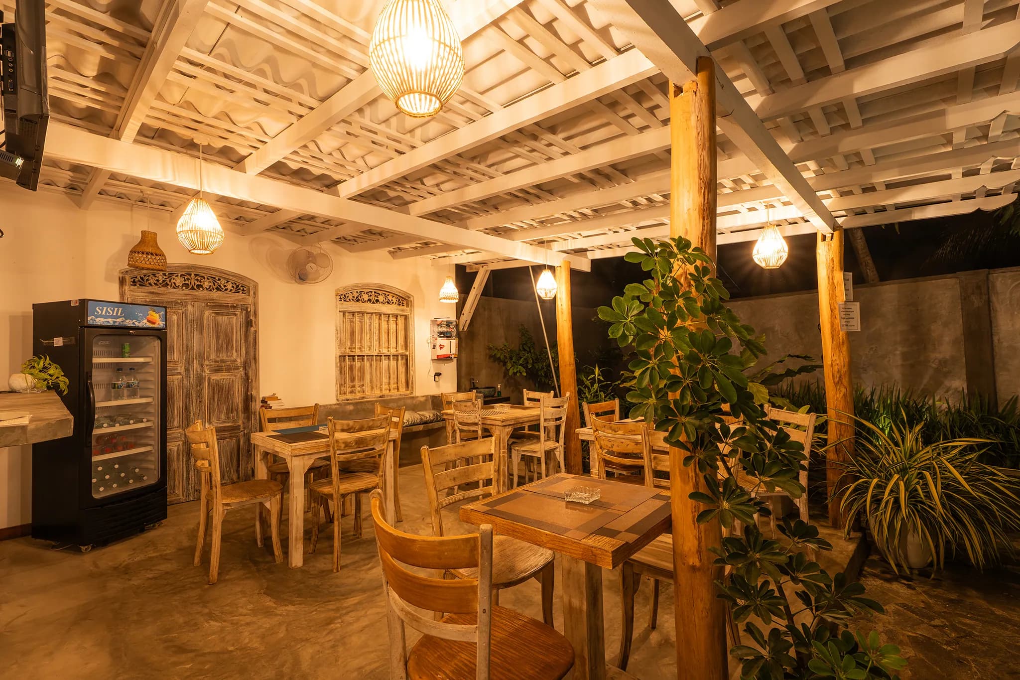 The restaurant at night, lit by woven lanterns