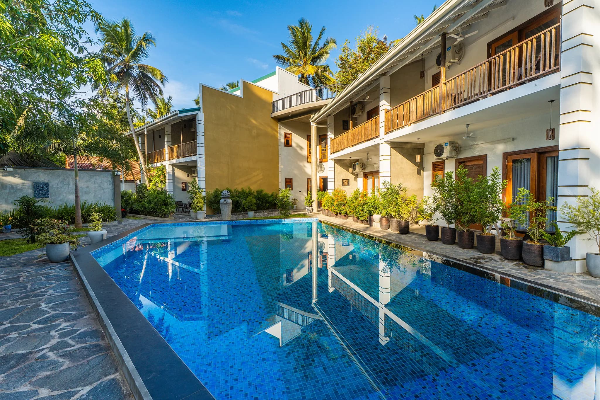 The pool and courtyard by day, balconies on two floors