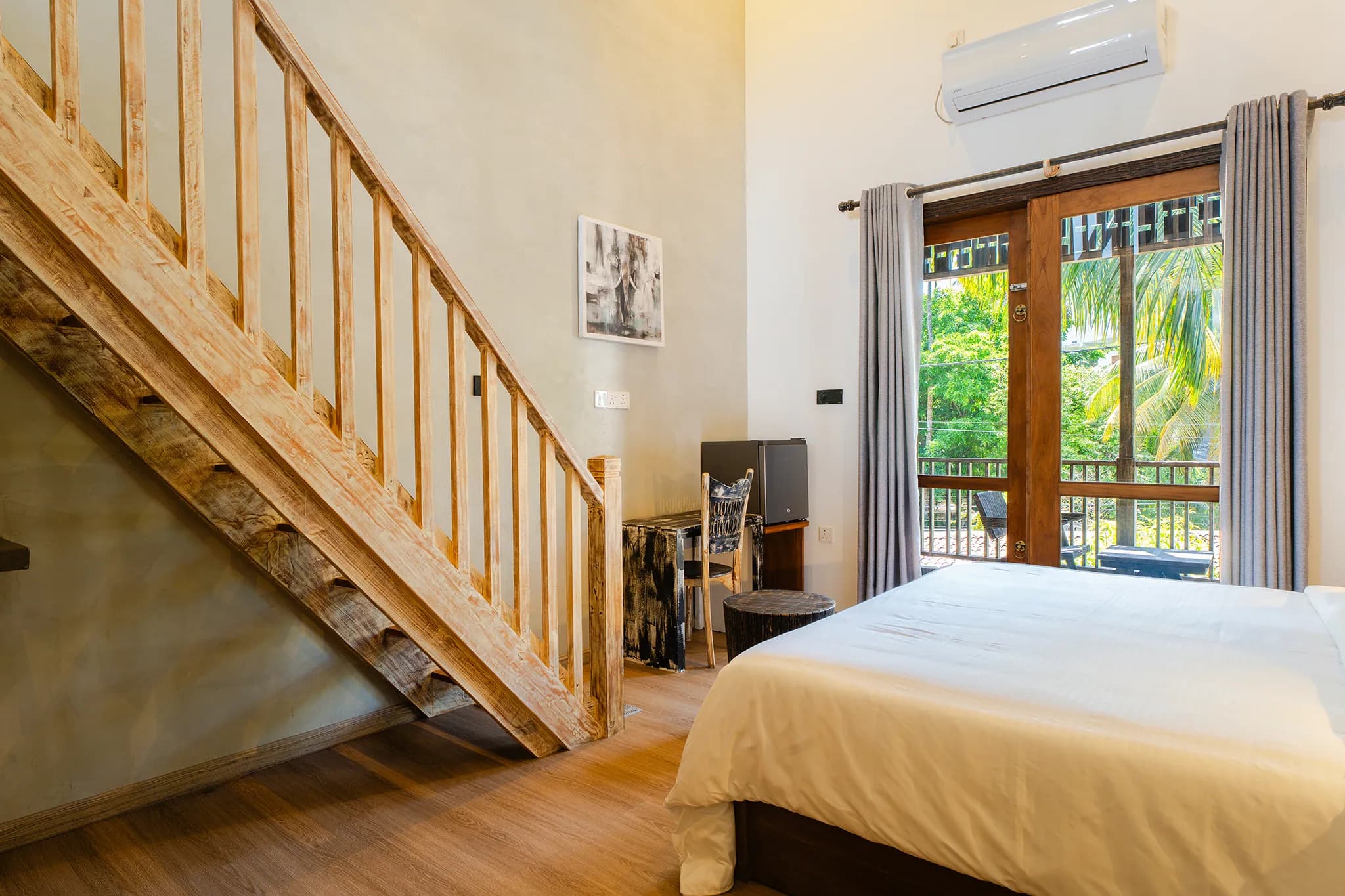 Timber staircase rising to a mezzanine bedroom